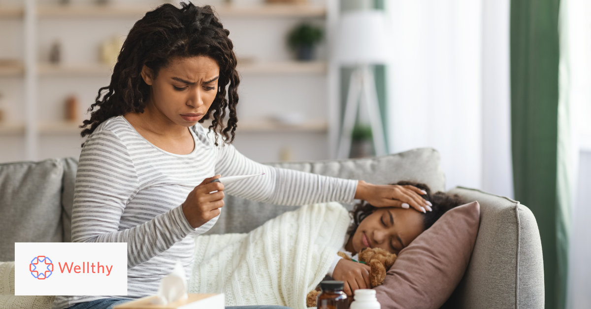 Worried mother takes sick daughter's temperature