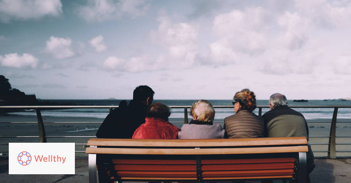 A family sitting on a bench overlooking the ocean.