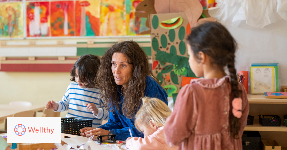 A mom is working with several kids in a homeschool classroom. 